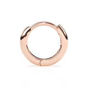 Huggie hoop earrings in rose gold.