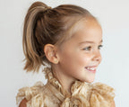 Child wearing Darling Bow, Clear CZ Stud Earrings in Yellow Gold with screwback post.