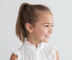 Child wearing Elegant Cross, Stud Earrings in Yellow Gold with screwback post.