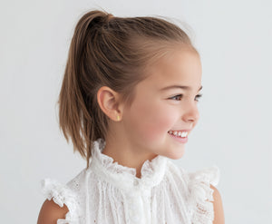 Child wearing Elegant Cross, Stud Earrings in Yellow Gold with screwback post.