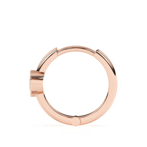 Rose gold huggie hoop earrings with a clear heart shaped stone.