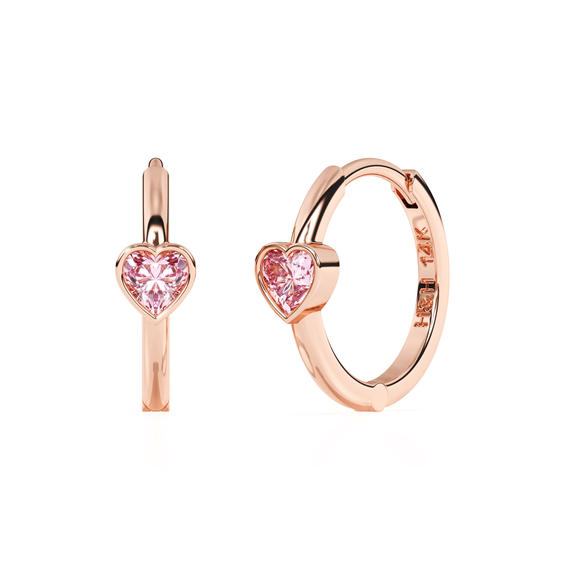 Rose gold huggie hoop earrings with a pink heart shaped stone.