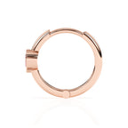 Rose gold huggie hoop earrings with a pink heart shaped stone.