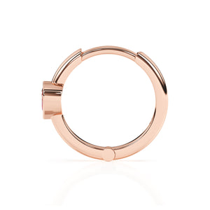 Rose gold huggie hoop earrings with a pink heart shaped stone.