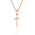 Rose gold cross necklace on a white background.