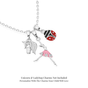 Sterling Silver necklace with ballerina pendant, unicorn, and ladybug charms on a white background.