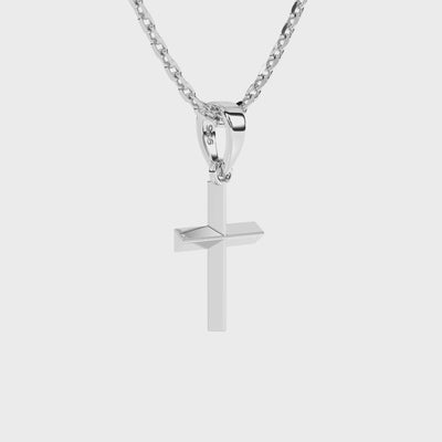 Sterling silver cross pendant on a necklace chain against a white background video.