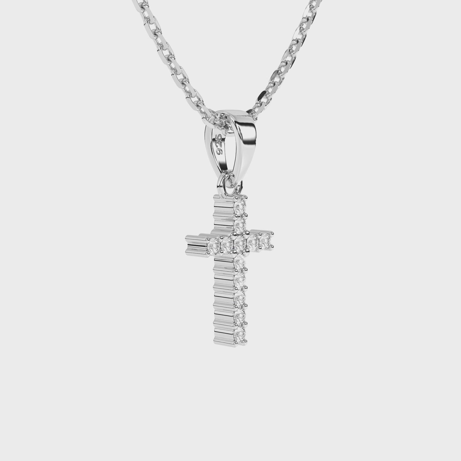 Sterling silver cross pendant with clear pave set CZ necklace on a white background video.