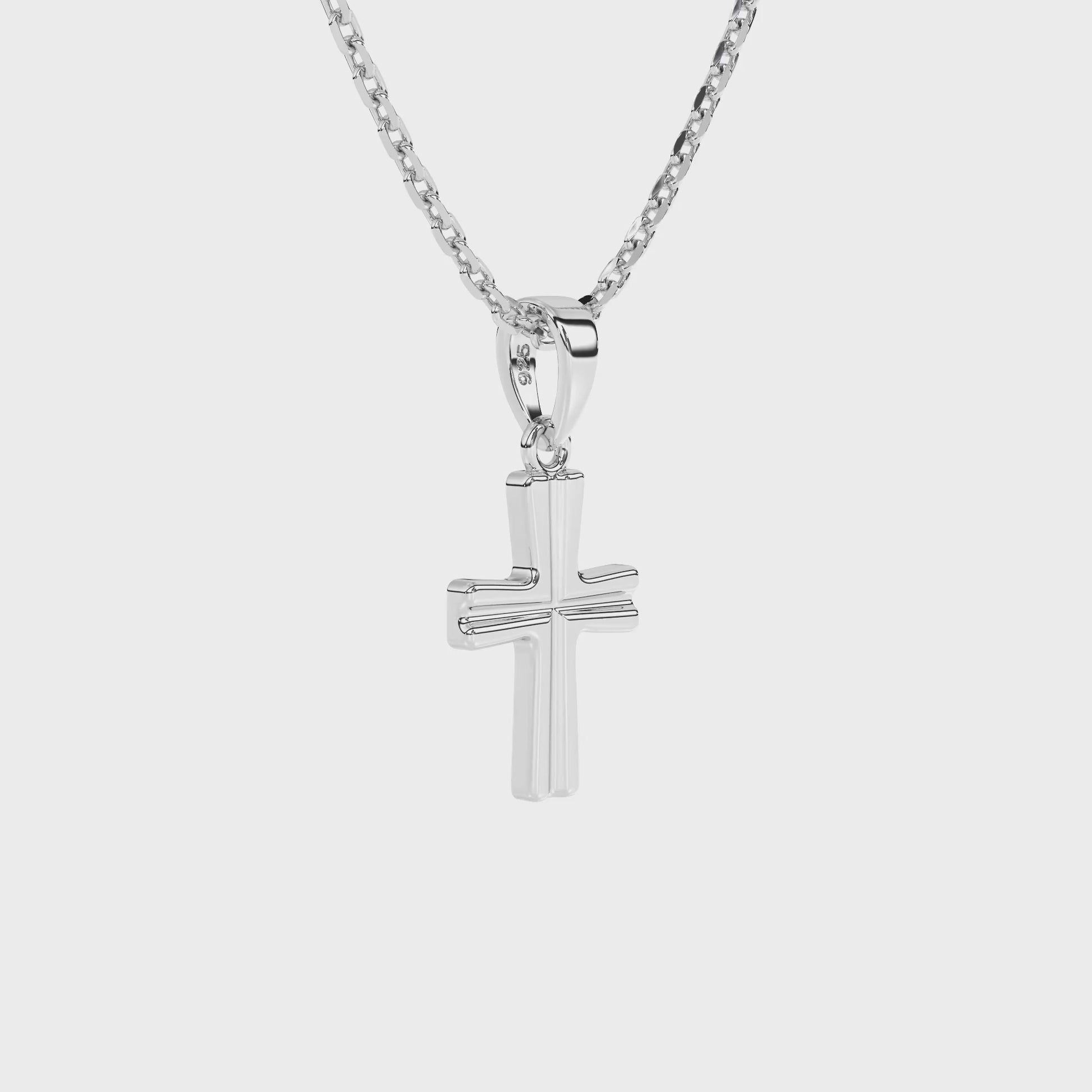 Sterling silver cross pendant on a chain against a white background video.