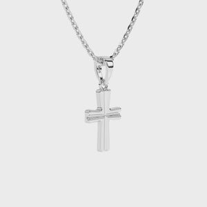 Sterling silver cross pendant on a chain against a white background video.