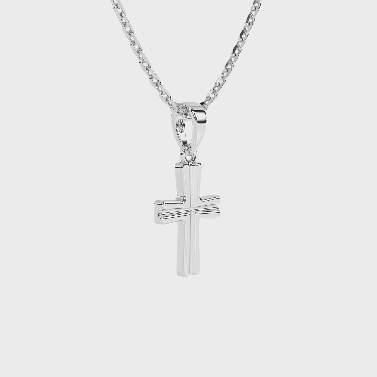 Sterling silver cross pendant on a chain against a white background video.