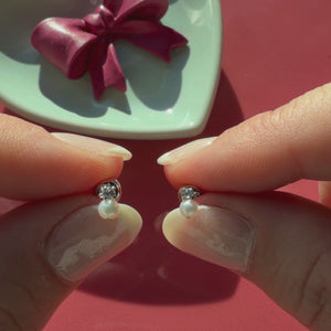 Video of 3mm pearl drop clear CZ stud earrings in solid 14K white gold held in hand to show their actual size for babies and children.