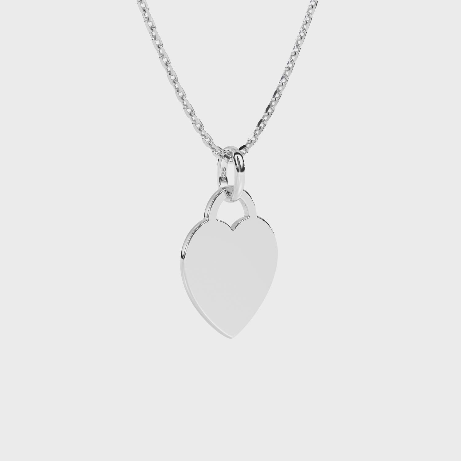 Sterling silver heart-shaped pendant on a necklace chain against a white background video.