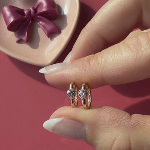 Endless Love, Pink Heart 14k Yellow Gold huggie hoop earring held in hand to show its actual size.