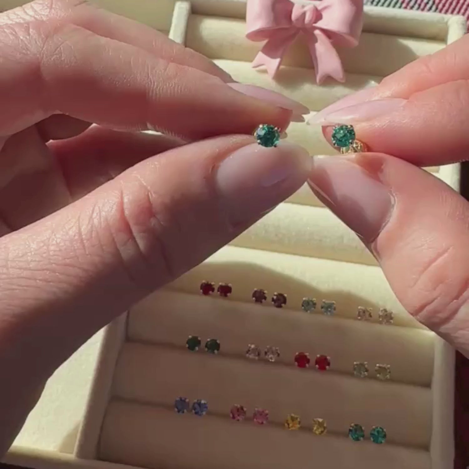 December Birthstone 14k Yellow Gold stud earring held in hand to show its actual size.