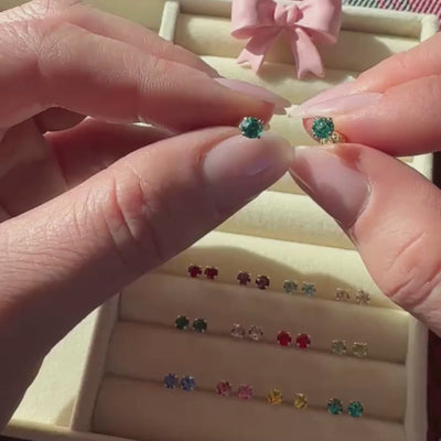 December Birthstone 14k Yellow Gold stud earring held in hand to show its actual size.