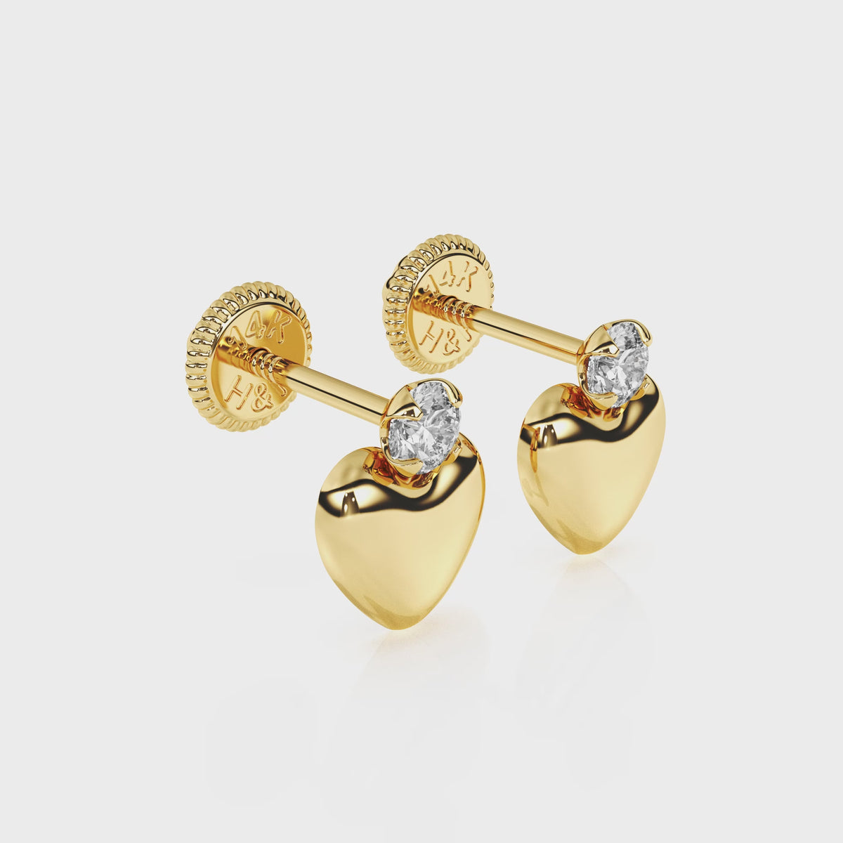 360-degree video of Shining Love puff heart clear CZ stud earrings in solid 14K yellow gold with screw-back posts.