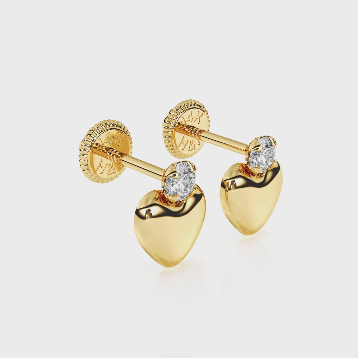360-degree video of Shining Love puff heart clear CZ stud earrings in solid 14K yellow gold with screw-back posts.