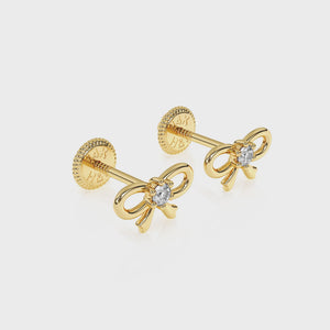 360-degree video of Darling Bow clear CZ stud earrings in solid 14K yellow gold with screw-back posts.