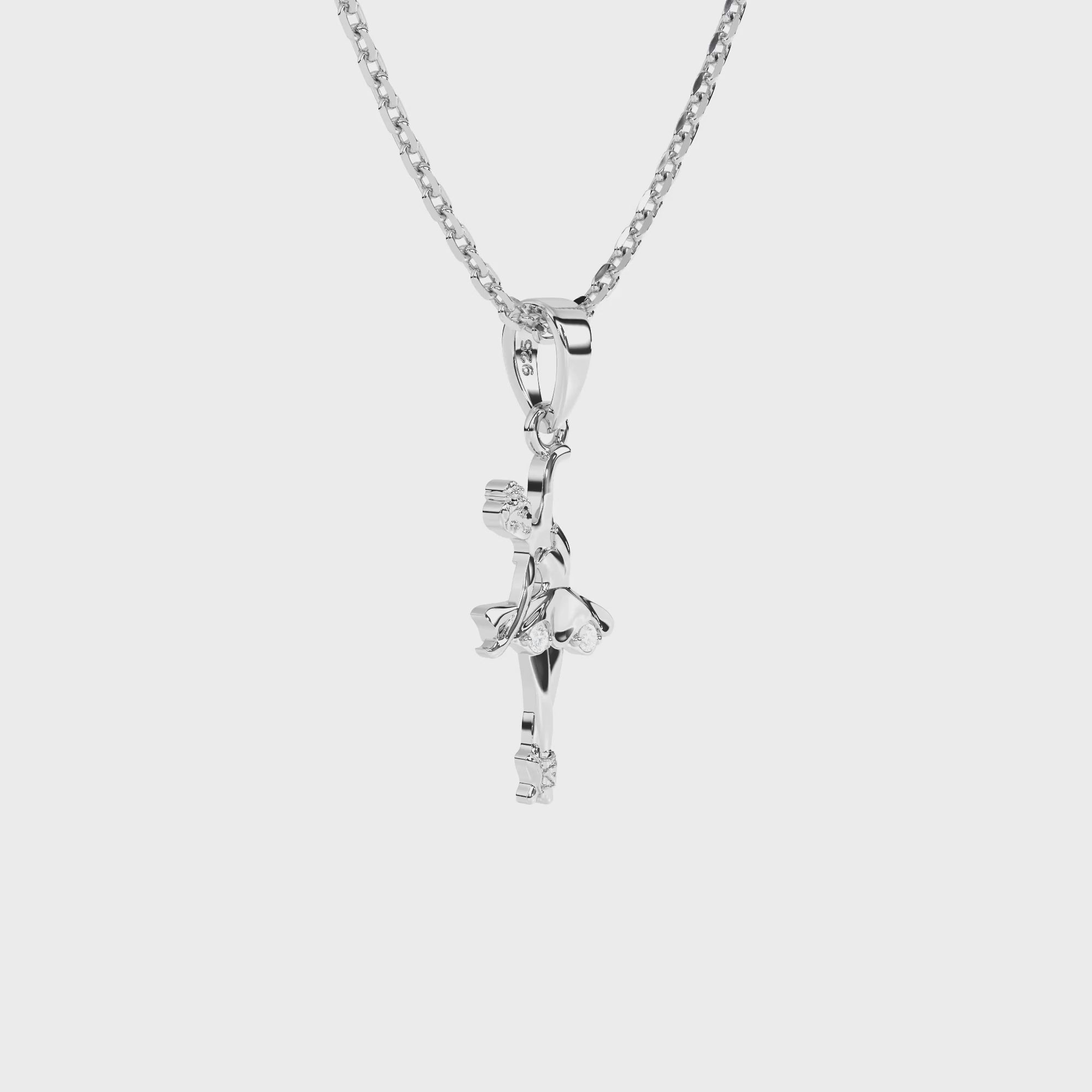 Sterling silver ballerina pendant with clear CZ stones on a necklace chain against a white background video.