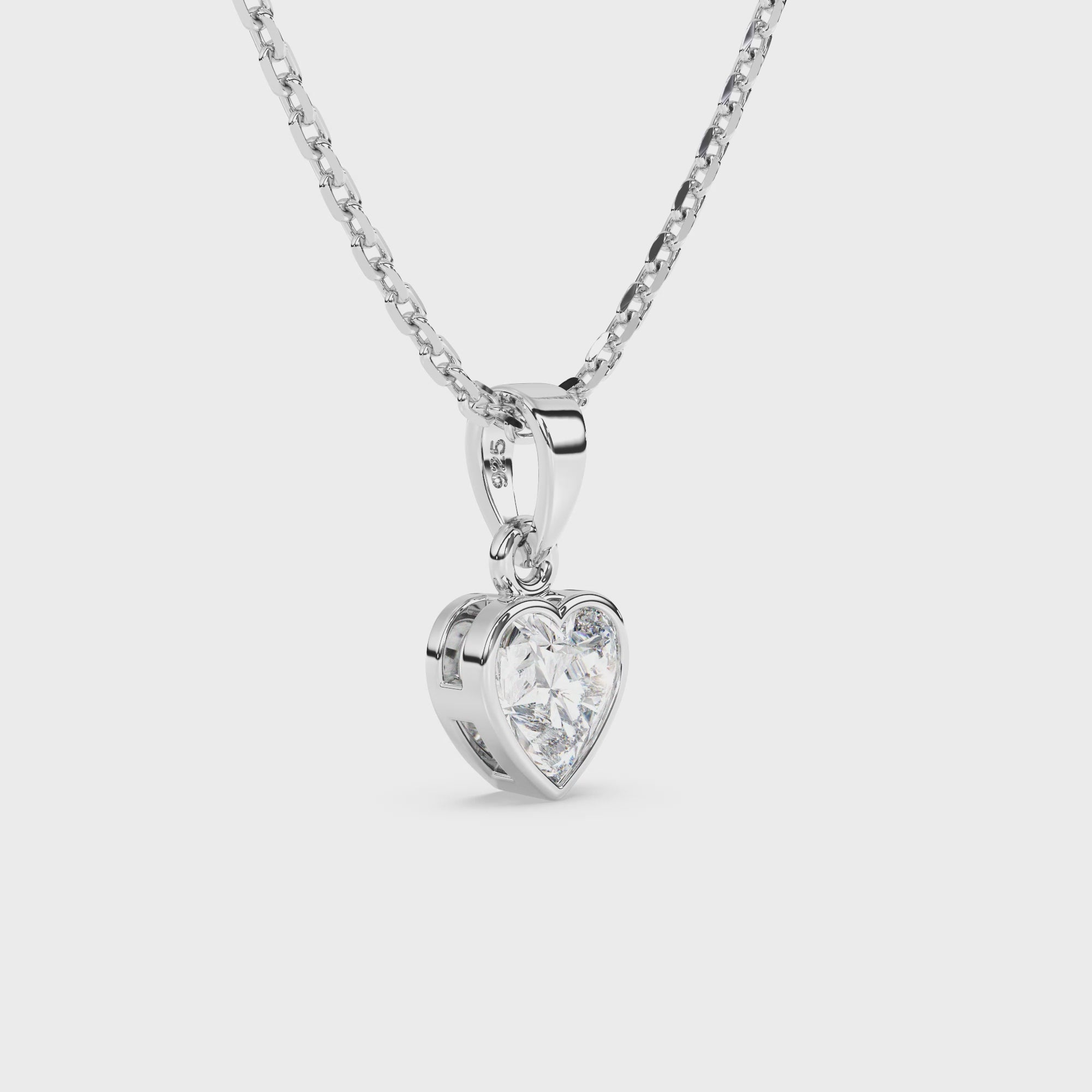 Heart-shaped clear CZ pendant on a necklace chain against a white background video.