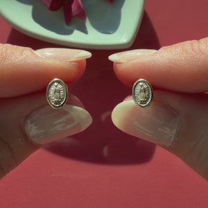 Video of Our Lady of Guadalupe stud earrings in solid 14K yellow gold held in hand to show their actual size for babies and children.