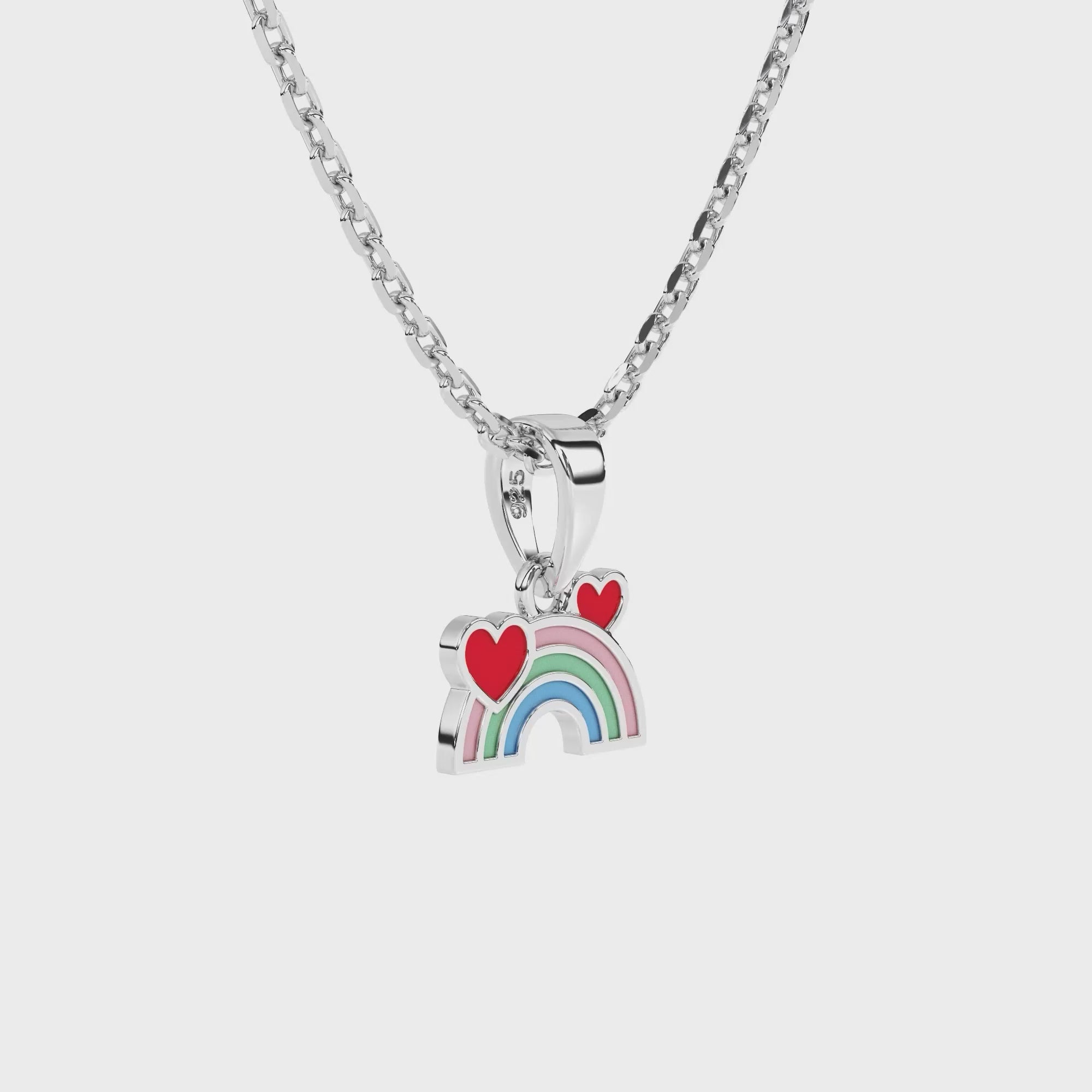 Sterling silver necklace with a rainbow and heart pendant on a white background video.